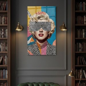 May include: A vertical glass wall art featuring a retro blonde woman portrait with black-and-white zebra pattern sunglasses, red lips, and a colorful geometric background.