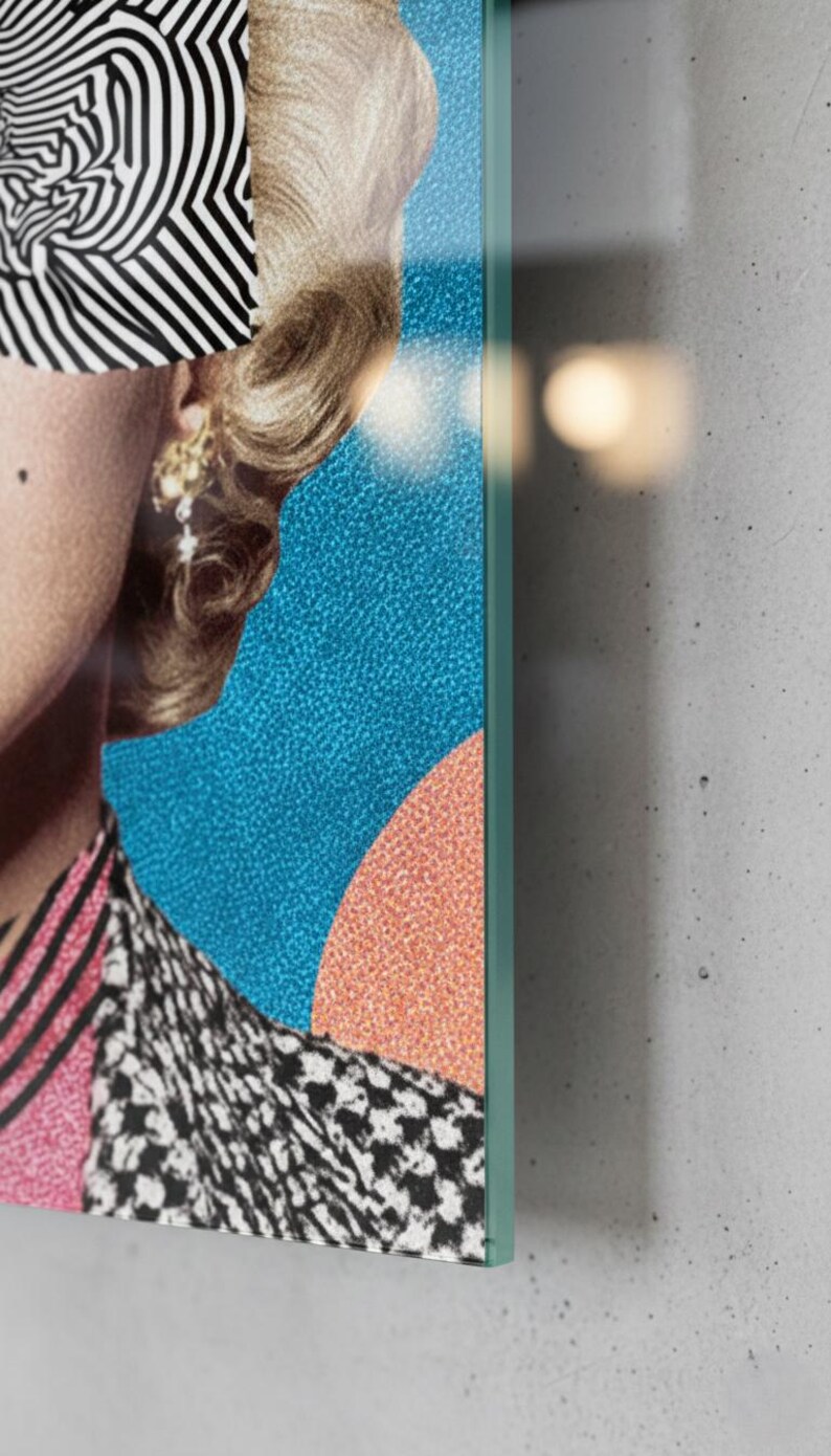 May include: A vertical glass wall art featuring a retro blonde woman portrait with black-and-white zebra pattern sunglasses, red lips, and a colorful geometric background.