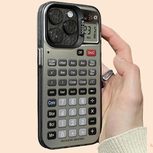 May include: A phone case designed to resemble a calculator. The case is silver and black with a screen displaying "23.5 8 INCH". It features buttons for various functions. The text "SO COOL" is printed on the side of the case.