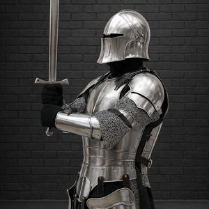 May include: A full suit of medieval armor, including a helmet, chest plate, and leg guards, is displayed. The silver-colored armor is worn over a black garment. The knight holds a long, silver sword in a defensive stance.
