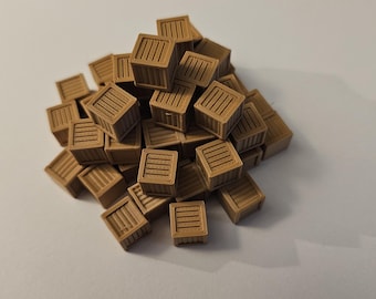 May include: A pile of small, brown wooden crates. Each crate has a rectangular shape with vertical lines on the front and top, resembling a miniature shipping container. The crates are scattered on a white surface.