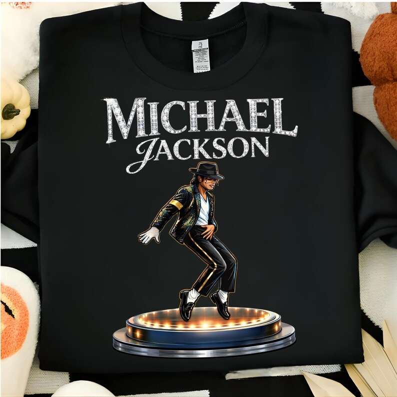 May include: Black sweatshirt featuring a graphic of Michael Jackson in a signature pose, wearing a black hat, jacket, and pants. The name "MICHAEL JACKSON" is printed above the image in a decorative font.