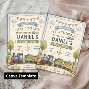 May include: Two rectangular birthday invitation cards featuring a watercolor train theme. The text reads ALL ABOARD! LET'S CELEBRATE DANIEL'S 2ND BIRTHDAY! with details for Saturday May 17 at 2:00 PM at The Station. A blue steam engine pulls green and yellow train cars.