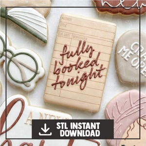 May include: Assortment of decorated cookies, including a book-shaped cookie with the words "fully booked tonight" in brown icing. Other cookies include glasses, a feather, and a heart-shaped cookie with text. The image also includes a black banner with the text "STL INSTANT DOWNLOAD".