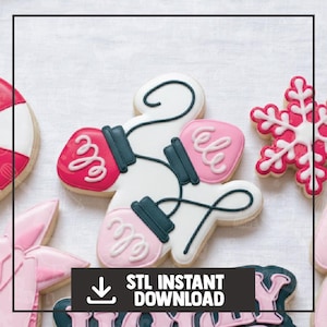 May include: Cookies in the shape of Christmas lights, a snowflake, and other holiday shapes. The Christmas light cookie is white with red and pink accents. The image includes the text "STL INSTANT DOWNLOAD".