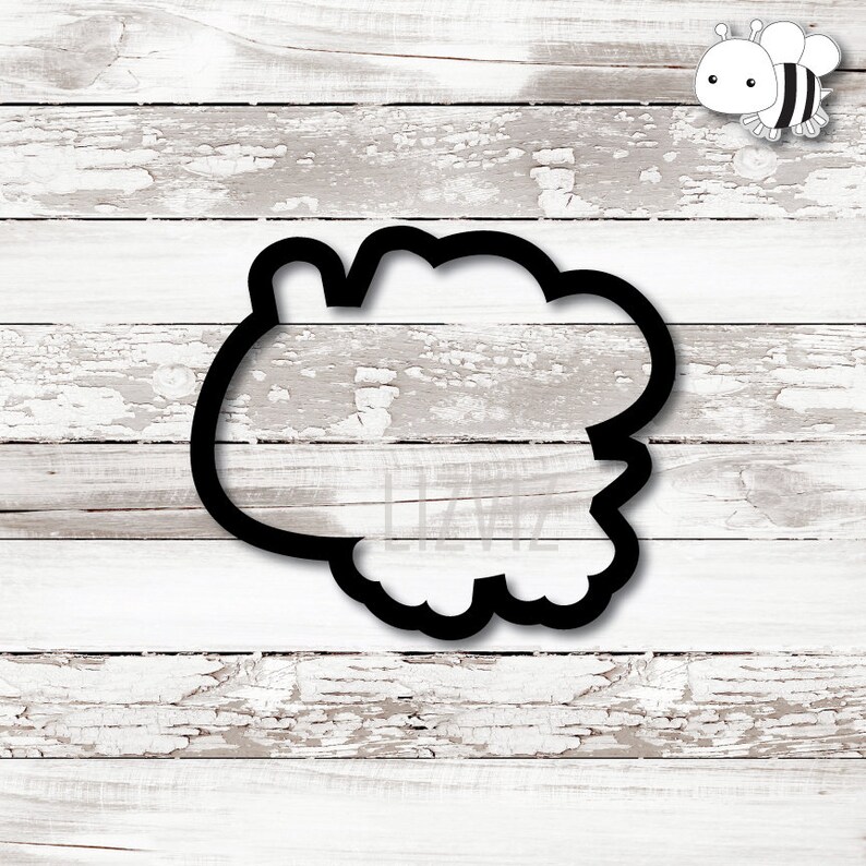 May include: Black cookie cutter shaped like a fluffy cloud with a rounded edge.