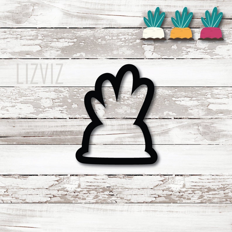 May include: Black cookie cutter shaped like a turnip with green leafy tops.