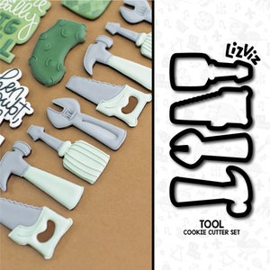 May include: A set of five cookie cutters shaped like tools, including a hammer, wrench, screwdriver, saw, and a  pliers. The cutters are black and are on a white background with a colorful pattern. The text "TOOL COOKIE CUTTER SET" is below the cutters.