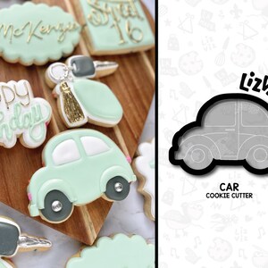 May include: A black metal cookie cutter shaped like a car. The cookie cutter is on a white background with a pattern of various shapes and designs. The text "LizViz" and "CAR COOKIE CUTTER" are printed on the background.