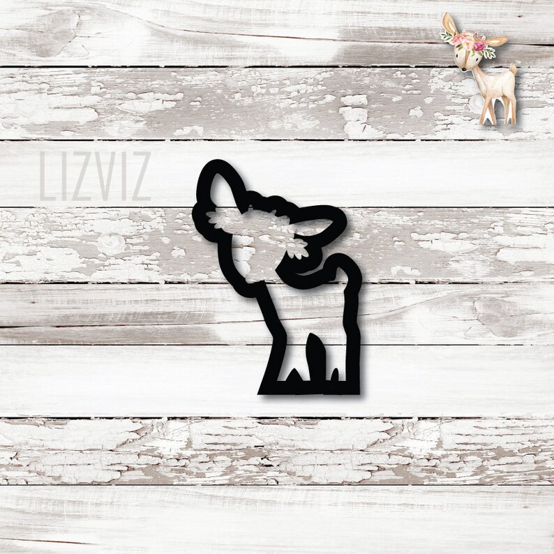 May include: Black silhouette of a deer with its head tilted up, looking at something above it. The deer is standing on a grassy patch.