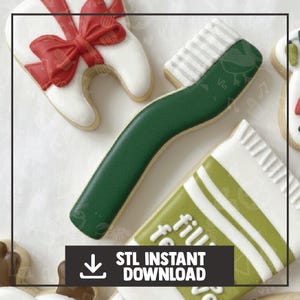 May include: A collection of decorated sugar cookies, including a green toothbrush, a tooth with a red bow, and a tube of toothpaste. The toothbrush has white bristles and a green handle. The toothpaste tube is white with green stripes and text. "STL INSTANT DOWNLOAD" text is also present.