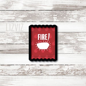 May include: A red packet-shaped design with the word "FIRE!" in white, featuring a flame graphic. The design has a black scalloped border and a white, bowl-shaped graphic. The background is a white, weathered wood.