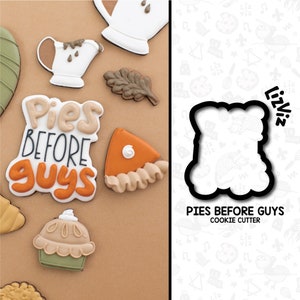 May include: A cookie cutter in the shape of a speech bubble with the text "Pies Before Guys" inside. The cookie cutter is made of metal and is designed for baking and decorating cookies.