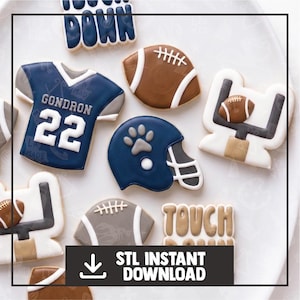 May include: A collection of football-themed sugar cookies featuring a blue jersey with the name GONDRON and number 22, a blue helmet with a paw print, brown footballs, white goalposts, and cookies with the text TOUCH DOWN.