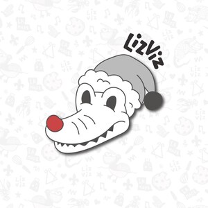 Puede incluir: Un cocodrilo blanco con un gorro de Pap&aacute; Noel gris con la nariz roja. El cocodrilo lleva un gorro de Pap&aacute; Noel con un pomp&oacute;n negro. El texto "Lizviz" est&aacute; escrito en negro sobre el cocodrilo.