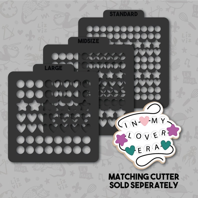 May include: Three black plastic stencils with different sizes labeled "Large", "Midsize", and "Standard". Each stencil has a grid of circles, hearts, and stars. The stencils are for crafting and decorating. The text "IN-MY LOVER ERA" is written in a decorative font with hearts and stars.