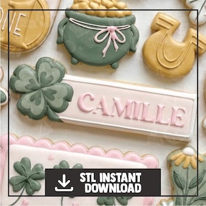 Può includere: Assortimento di biscotti a tema San Patrizio, tra cui un pentolone d'oro, un ferro di cavallo e dei trifogli. Un biscotto riporta il nome "Camille" in lettere rosa. L'immagine include anche il testo "STL INSTANT DOWNLOAD".