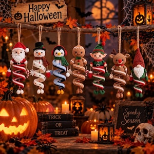 May include: Seven crocheted holiday ornaments hanging from a branch, including a Santa, snowman, penguin, gingerbread person, elf, reindeer, and gnome. Each figure features a spiral-shaped body and is suspended by a twine loop for display.