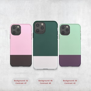 May include: Three phone cases in pink, green, and mint green with contrasting bottom sections in brown, white, and purple. Each case has a camera module and a two-tone color scheme. The image includes text indicating background and contrast levels.