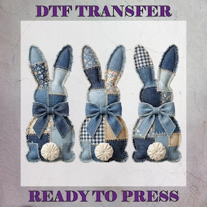 May include: Three denim bunny rabbit shapes with patchwork patterns, each featuring a blue bow and a white pom-pom tail. The image includes the text "DTF TRANSFER" and "READY TO PRESS".