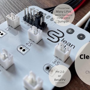 May include: A Tiny CleanBoard 1s serial charging board with white connectors and the text "1-6 1s LiPo at the same time". Features include 3A max current and easy storage mode.