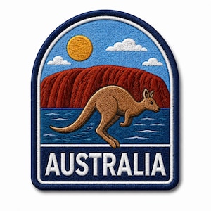 May include: An embroidered patch with a rounded top edge featuring a brown kangaroo leaping in front of a large red rock formation, a blue body of water, a yellow sun, and white clouds against a blue sky, with the word AUSTRALIA in white text.