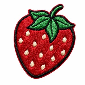 May include: A strawberry-shaped embroidered patch featuring a vibrant red fruit body with a black stitched border. The design includes bright green leaves at the top and several small, light cream-coloured seed details scattered across the surface.