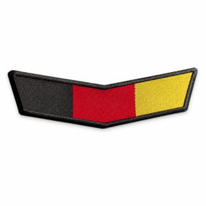 May include: A chevron-shaped embroidered patch featuring three vertical color blocks in black, red, and yellow. The patch has a thick black stitched border and a pointed center, creating a distinct V-shape design suitable for attachment to fabric.