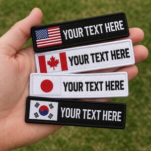 May include: Four rectangular embroidered patches with black or white borders. Each patch features a national flag on the left and the text YOUR TEXT HERE in black or white capital letters on the right side, including the USA, Canada, Japan, and South Korea.