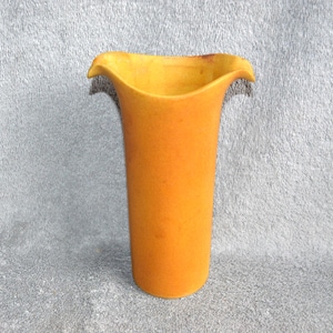 May include: A tall, orange vase with a flared, petal-like rim. The vase has a cylindrical body and a textured surface. The color is a warm, inviting orange. This decorative vase is suitable for floral arrangements.