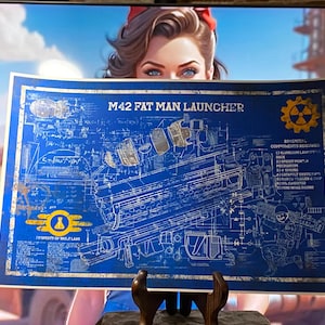 May include: A blue blueprint-style poster with the text "M42 FAT MAN LAUNCHER" and technical diagrams. The poster features a yellow and blue logo and a list of components. The background shows a woman with a red bow and a vintage car.