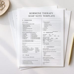 May include: A stack of white paper with the text "HORMONE THERAPY SOAP NOTE TEMPLATE" printed in black. A gold pen rests on the paper, and a small beige tray with a gold paperclip is in the upper left corner.