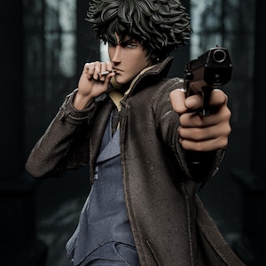 May include: A detailed figurine of a dark-haired character wearing a brown trench coat over a blue suit, holding a black handgun pointed forward with one hand while holding a cigarette to their lips with the other hand, captured in a realistic style.