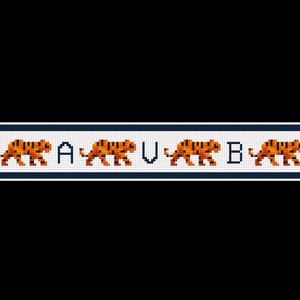 May include: A cross-stitch design featuring four orange tigers with black stripes, alternating with the letters A, U, and B. The design is set against a white background with a navy blue border, perfect for a craft project.