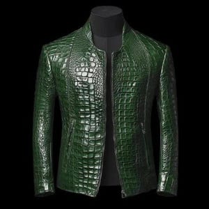 May include: A green, textured leather jacket with a crocodile skin pattern. The jacket has a stand-up collar, a front zipper, and two side pockets. The jacket is displayed on a black mannequin.