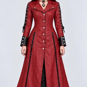 May include: A long, deep red coat featuring a notched lapel, silver-toned buttons down the front, and black vertical zipper accents. The sleeves include black lace-up detailing along the outer arms and black cuffs with silver-toned button hardware.