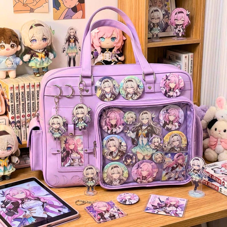 May include: A lilac satchel bag with character pins and keychains. The bag has a clear front pocket filled with character pins. Plush dolls and figurines are arranged around the bag, creating a themed display.