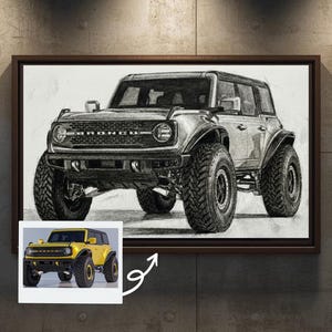 May include: A framed pencil drawing of a black and white off-road vehicle. The drawing is in a dark brown frame and is mounted on a textured gray wall. A smaller image of a yellow vehicle is in the lower left corner.