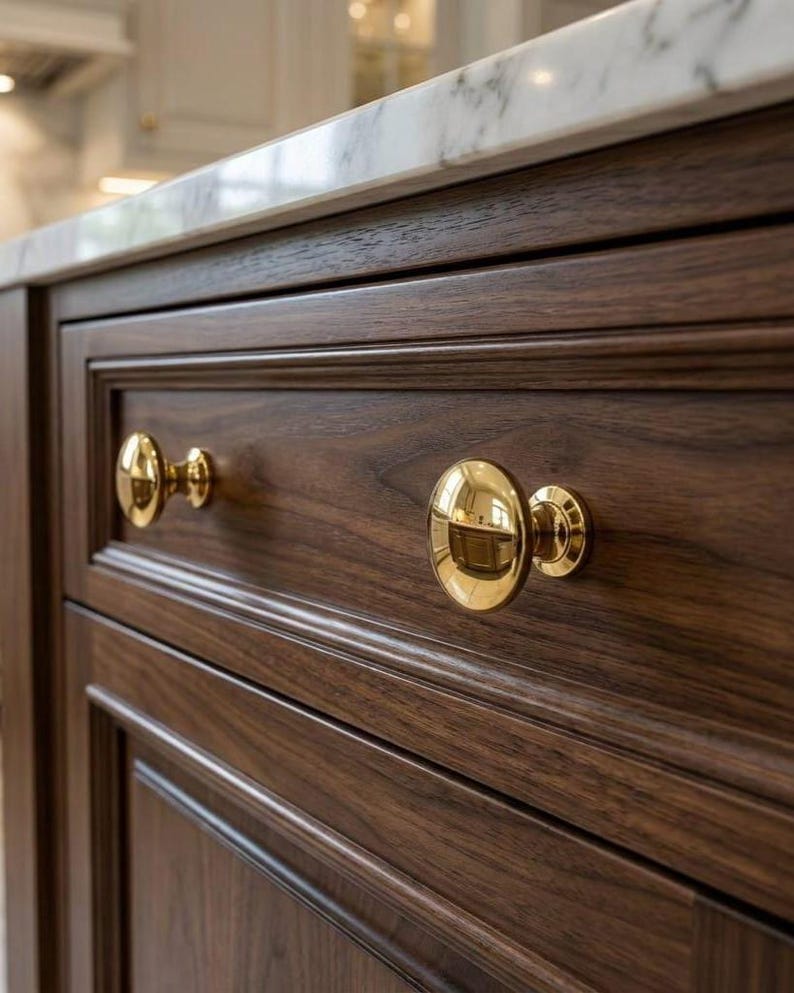 Solid brass cabinet knob with polished gold finish.