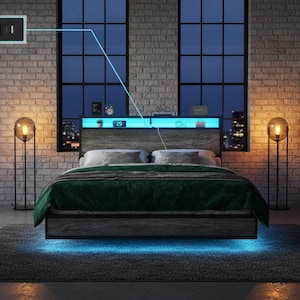 May include: A modern bed frame with a gray headboard and a green blanket. The bed has built-in lighting and a shelf with a digital clock. The room features large windows, brick walls, and globe-shaped lamps.