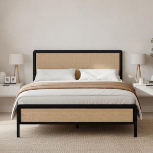 May include: A modern bed frame with a black metal frame and a woven rattan headboard and footboard. The bed is made up with white bedding and a tan throw blanket. Two white nightstands with lamps flank the bed.