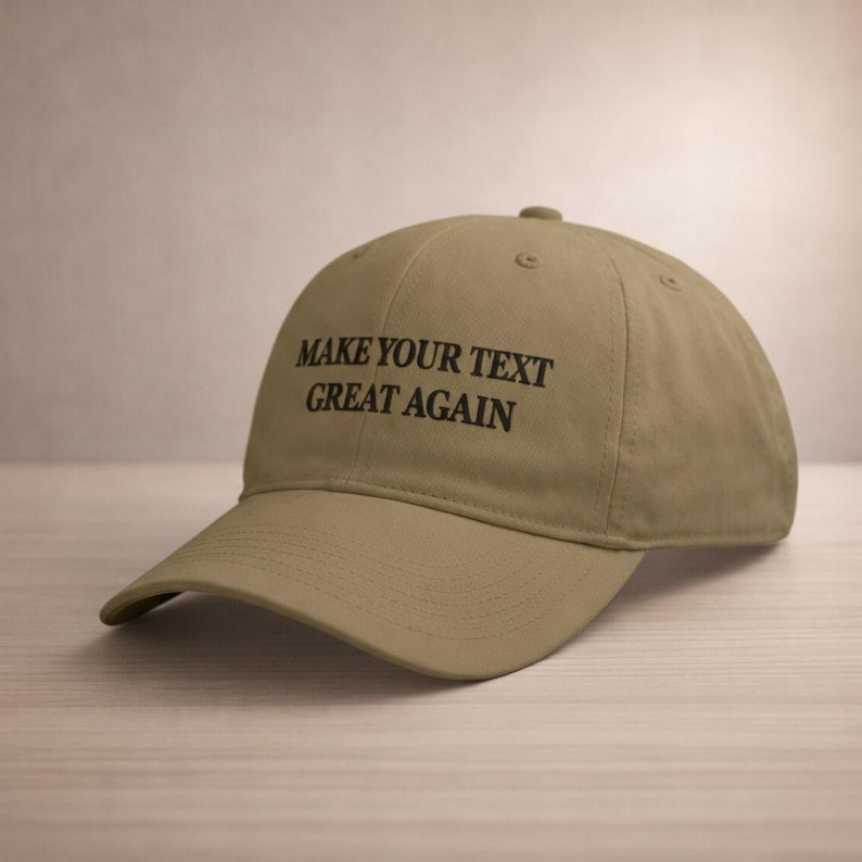 May include: A khaki-colored baseball cap with the text "MAKE YOUR TEXT GREAT AGAIN" in black. The cap has a curved brim and a rounded crown, suitable for casual wear.