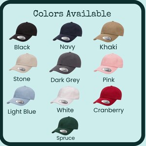 May include: A collection of baseball caps in various colors, including black, navy, khaki, stone, dark grey, pink, light blue, white, cranberry, and spruce. The text "Colors Available" is at the top.