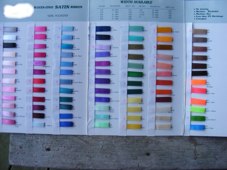 May include: A colour chart of woven-edge satin ribbon in various colours and widths. The chart includes the ribbon's width in inches and millimetres, as well as the width number. The chart also includes information about the ribbon's care, such as no ironing, machine washable, machine dry, less than 2% shrinkage, and colourfast.