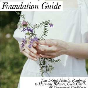 May include: A book cover titled "The Fertility Foundation Guide" with text about hormone balance and conception. The image features a person holding a bouquet of purple and green flowers, wearing a white dress.