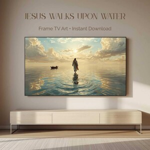 May include: A digital artwork titled JESUS WALKS UPON WATER Frame TV Art Instant Download displayed on a television screen. The image depicts a figure walking on calm water toward a sunset with clouds, with a small boat visible in the distance.