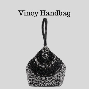 May include: A black beaded handbag with a handle. The bag is decorated with silver and black beads in a pattern. The text "Vincy Handbag" is above the bag.