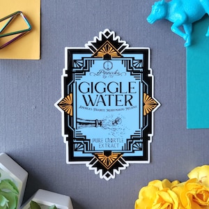 May include: A sticker with a light blue background and black and gold art deco style border. The sticker reads "Giggle Water" with the text "America's Favorite Merrymaking Melange" and "Pure Chortle Extract".