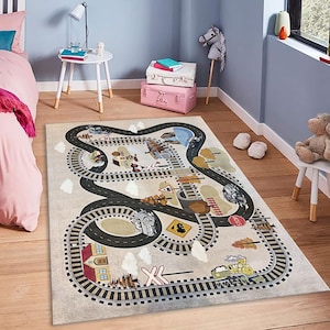 May include: A rectangular children's rug featuring a whimsical train track design. The rug has a beige background with black roads and train tracks. Colorful illustrations of trains, cars, and buildings are scattered throughout the design. The rug measures approximately 60 inches by 40 inches.
