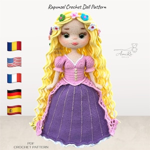May include: A crochet doll with long yellow hair adorned with small colourful flowers, wearing a pink bodice and a purple skirt. The text reads Rapunzel Crochet Doll Pattern, AmiRo Dolls, and PDF Crochet Pattern. The doll has large eyes.